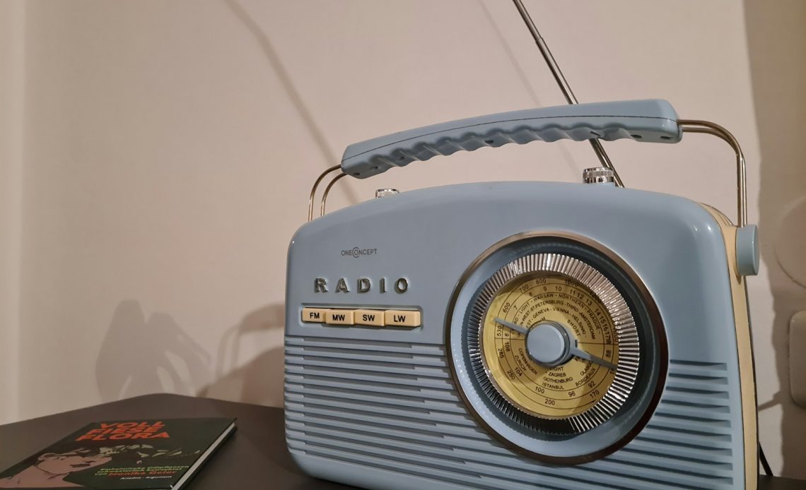 a radio sitting on top of a table next to a book