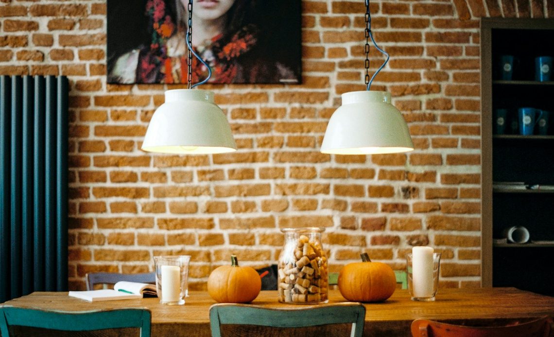 rectangular brown wooden table with two pumpkin on top